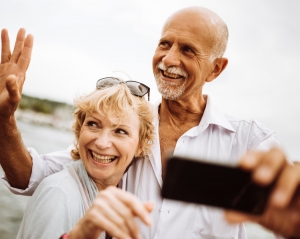 Older couple taking a selfie.