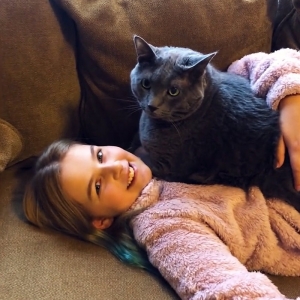 Karis with her cat on couch.