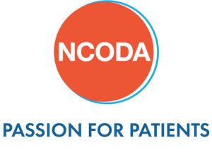 National Community Oncology Dispensing Association logo with white acronym in an orange circle above blue text "passion for patients."