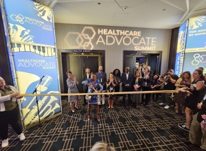 Woman with giant scissors cuts ribbon in front of crowd