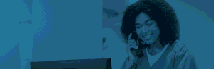 Nurse on the phone taking an order in front of a computer.